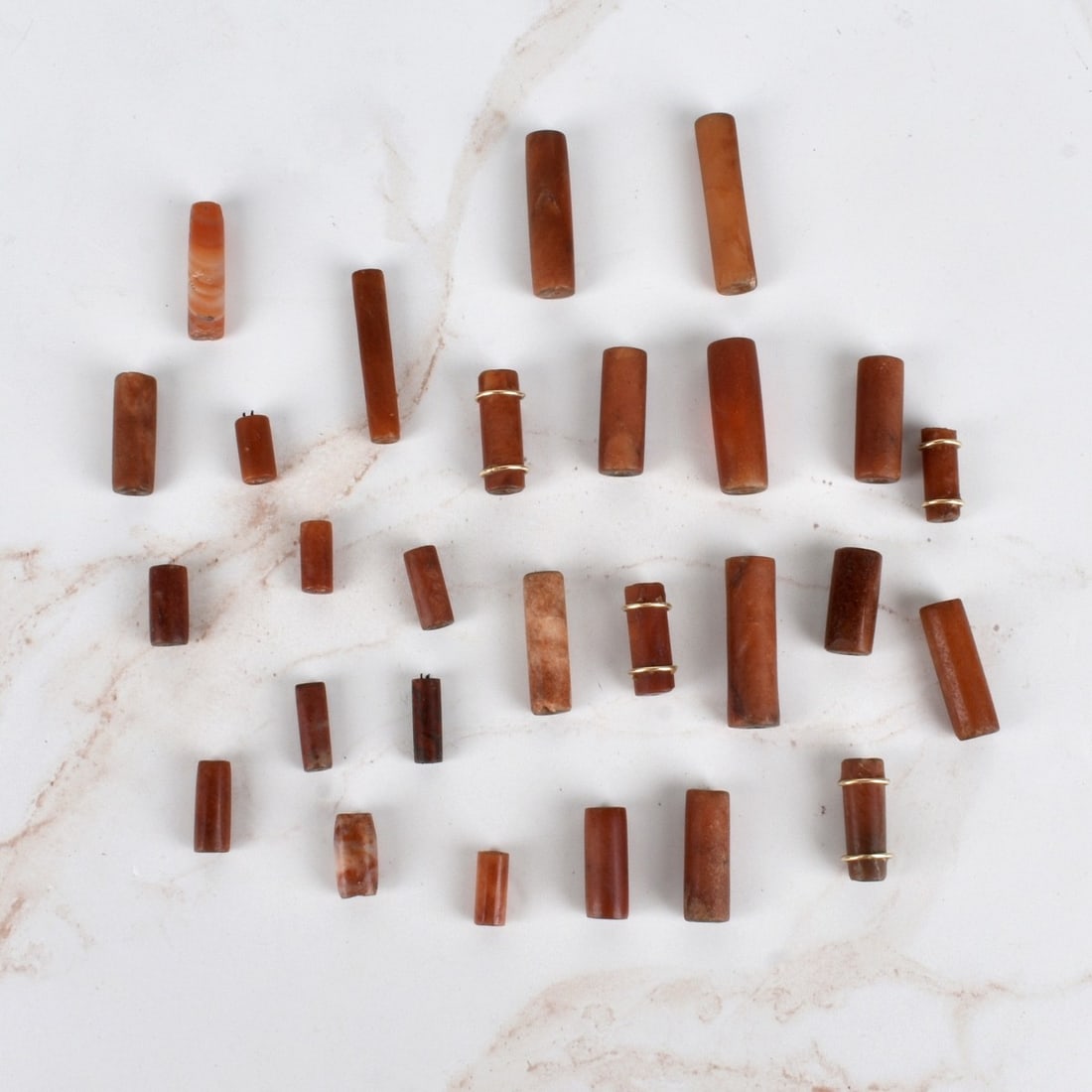 19C Carnelian Beads: Antique 19th Century Carnelian Beads. Twenty Seven (27) 4 with gold bands. Smallest 1/2" largest 1-1/2" Condition: Good Condition, needs to be restrung. Estimate: $50.00 - $150.00 Domestic Shipping: $