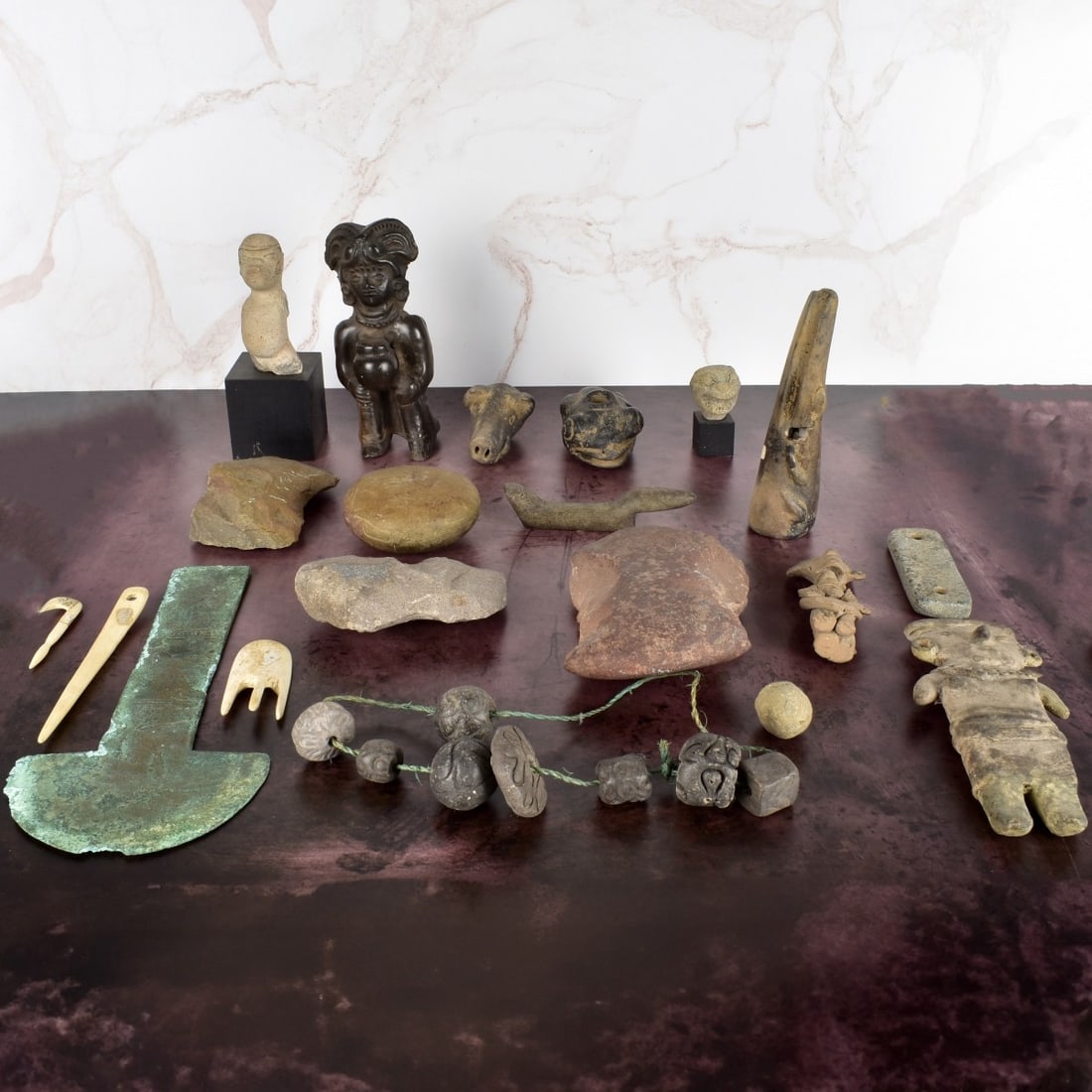South American Indian Artifacts: South American Indian Artifacts, some human Effigys one on a stand, a necklace, a pig, a crocodile, a metal piece, a cleat, bone instruments and a bunch of rocks. Approximately 2l pieces. Condition: G