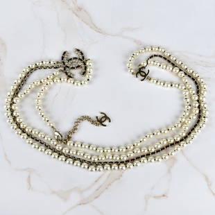 Chanel CC Belly Chain: Chanel Multi Strand Faux Pearl Belly Chain with Double C with Inset Crystal Charm. Chanel pouch to accompany the lot. Pearl size: 8mm. Overall length 40-1/2". Provenance: The Orianne Collins