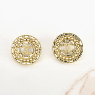 Chanel Earrings: Pair of Chanel CC Gold Tone Faux Pearl Earrings with Original Box. Measures 1" diam. Provenance: The Orianne Collins Collection. A large portion of proceeds of this sale will be donated to Ms Collins�