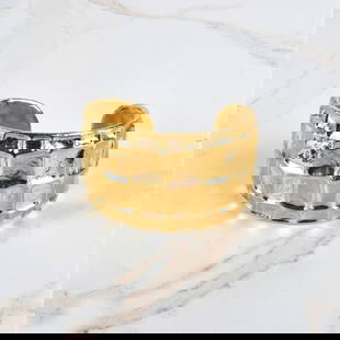 Chanel Metiers D'Arte Cuff Bracelet: Chanel Metiers D'Arte Gold Tone Metal Cuff Bracelet. CC monogram on the surface. Chanel pouch to accompany the lot. Measures 5" interior diam., 1-5/8" D x 2-1/2" W. Provenance: The Orianne Collins Col
