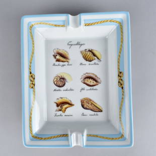 Hermes Paris "Coquillages" Cigar Ashtray: Hermes Paris "Coquillages" Porcelain Cigar Ashtray. Signed Hermes Paris. Measures 1-1/2"H x 8"L x 6-1/2"W. Provenance: The Orianne Collins Collection. A large portion of proceeds of this sale will be