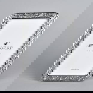 Pr Swarovski Minera Picture Frames: Pair Swarovski Minera Picture Frames surrounded by Swarovski Crystals, in original box with paperwork. .Measure 7"L x 5"W .PProvenance: The Orianne Collins Collection. A large portion of proceeds of t