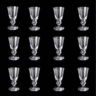 Twelve Steuben Glass Water Goblets: Set of Twelve Steuben Model 7877 Glass Water Goblets in Original Box. Dust bags to accompany the lot. Signed Appropriately. Measures 6-3/4", 3-1/2" diam. Box measures 8" x 16" x 12". Condition: All in