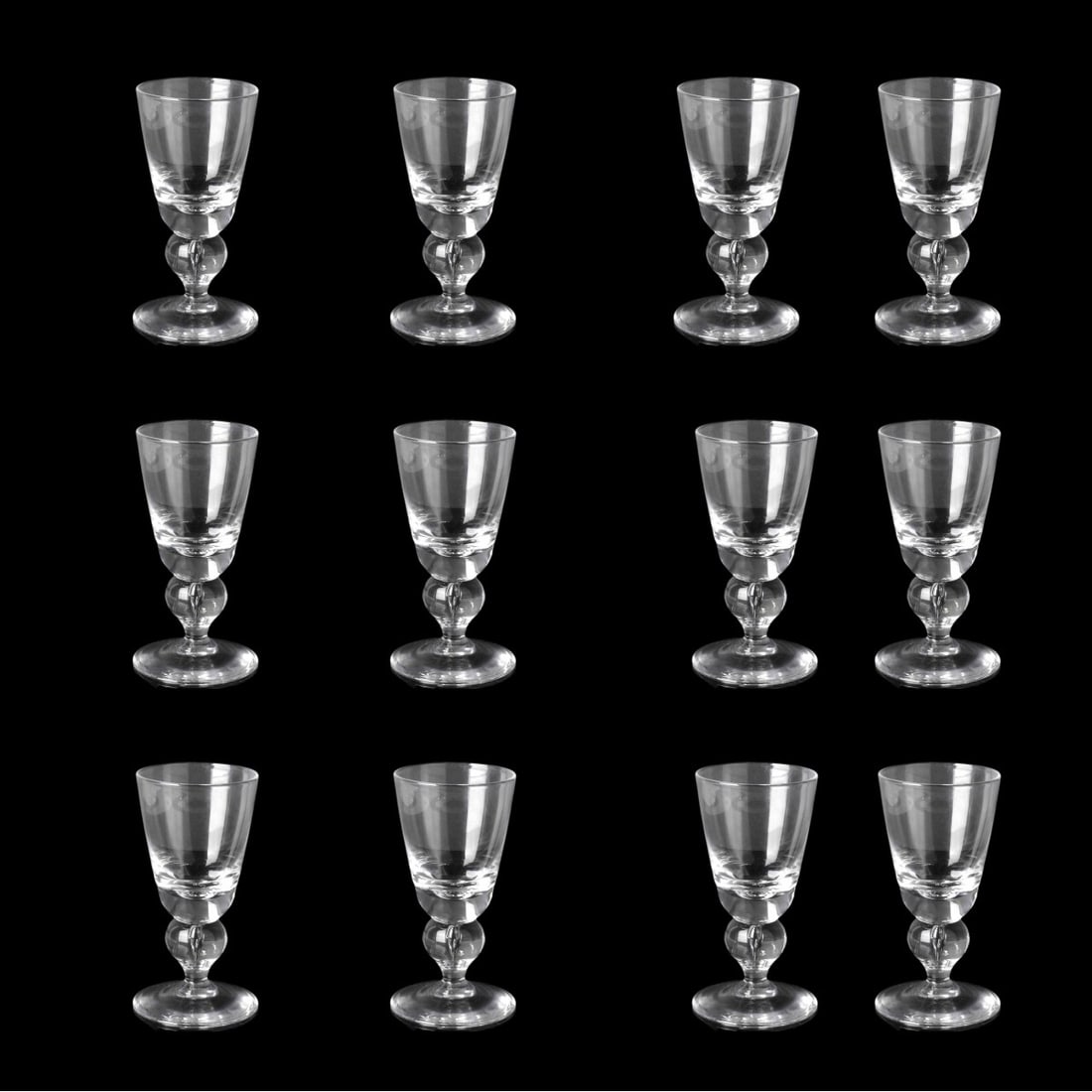 Twelve Steuben Wine Glasses: Set of Twelve Steuben Model 7877 Glass Wine Glasses in Original Box. Dust bag to accompany the lot. Signed approperately. Glass measures 5-1/8" x 2-1/2". Box measures 5-1/2" x 9" x 12". Condition: All