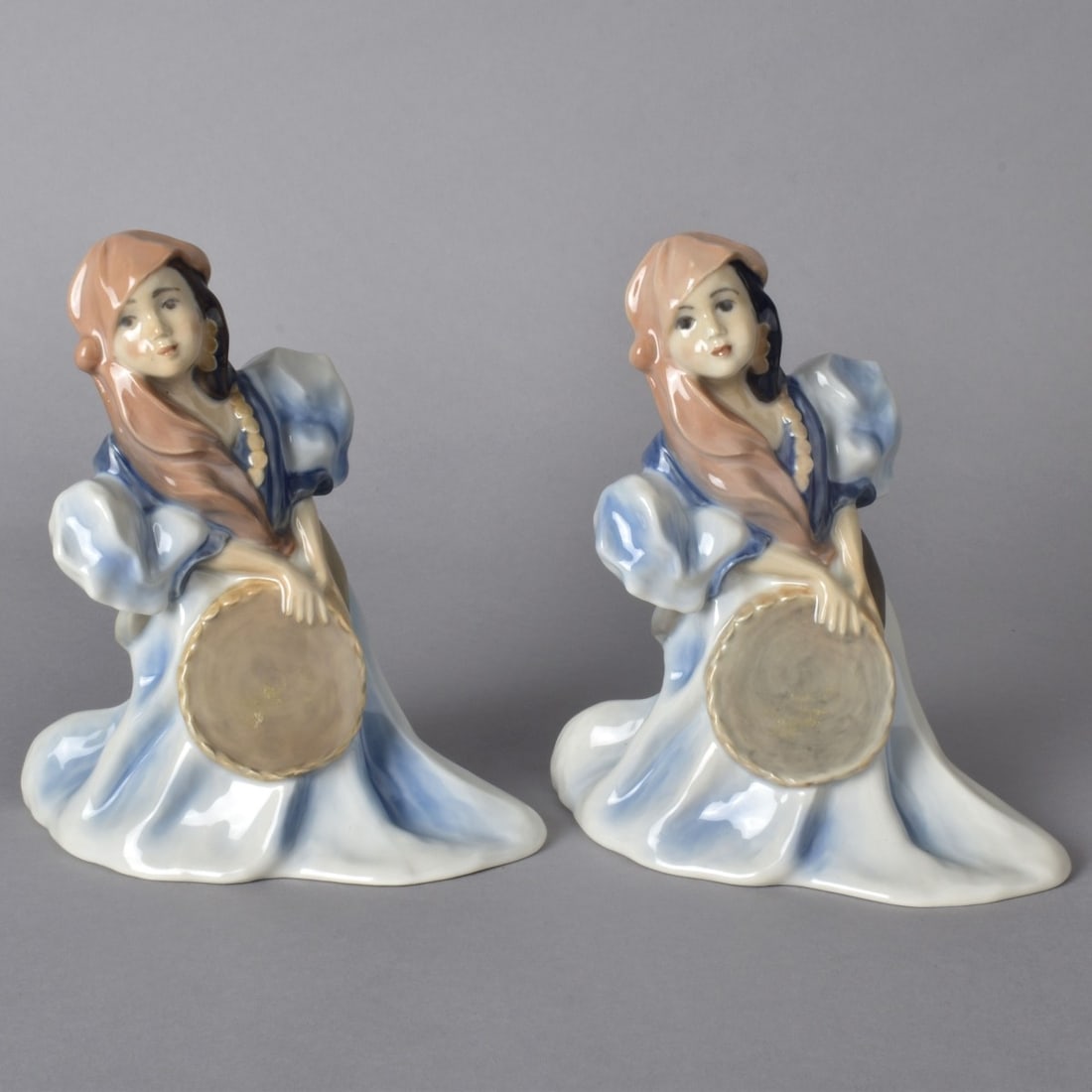 Two Royal Copenhagen Porcelain Figurines: Lot of Two Royal Copenhagen "Gypsy Girls" Glazed Porcelain Figurines. Signed. Measures 7-1/8" x 6-3/8" x 3-1/4". Condition: Both are in good condition. Estimate: $50.00 - $150.00 Domestic Shipping: $7