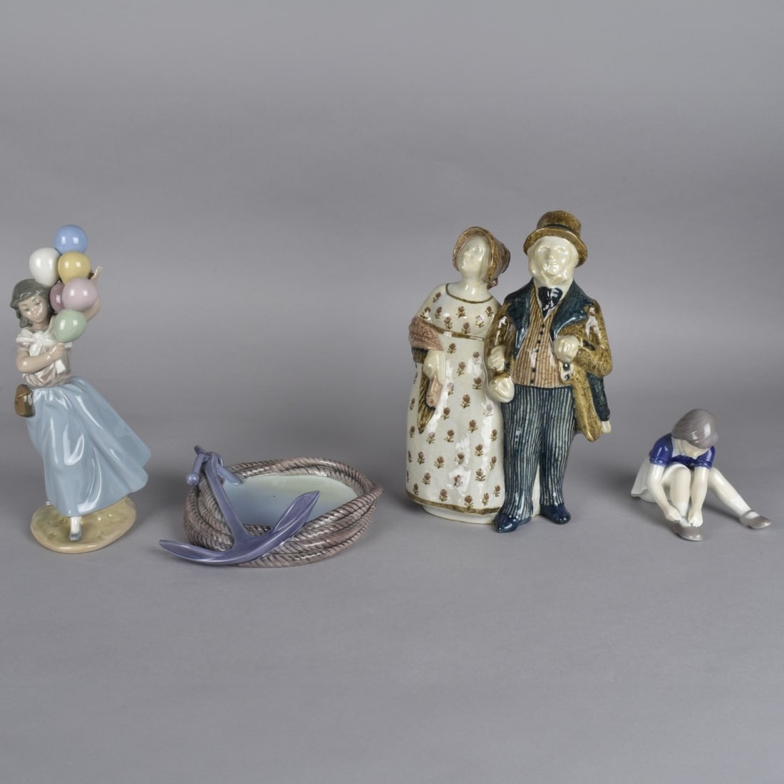 Four Vintage Porcelain Figurines: Grouping of Four Vintage Porcelain Figurines. Includes (1) Lladro figurine together with (3) B&G porcelain figurines. Each marked on the base. Tallest B&G figurine measures 10-3/4" x 7". Lladro measur