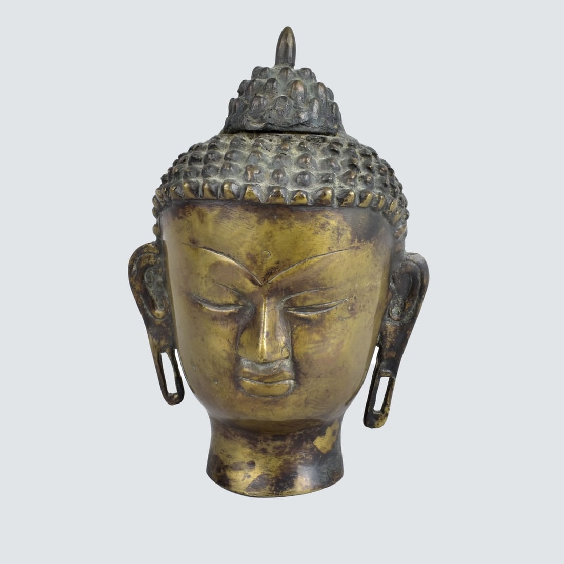 Antique Thai Bronze Head of Buddha: Antique Thai Bronze Head Depicting Buddha. Measures 8" x 5" x 4". Condition: Normal rubbing to the patina otherwise good condition. Estimate: $100.00 - $150.00 Domestic Shipping: $55.00