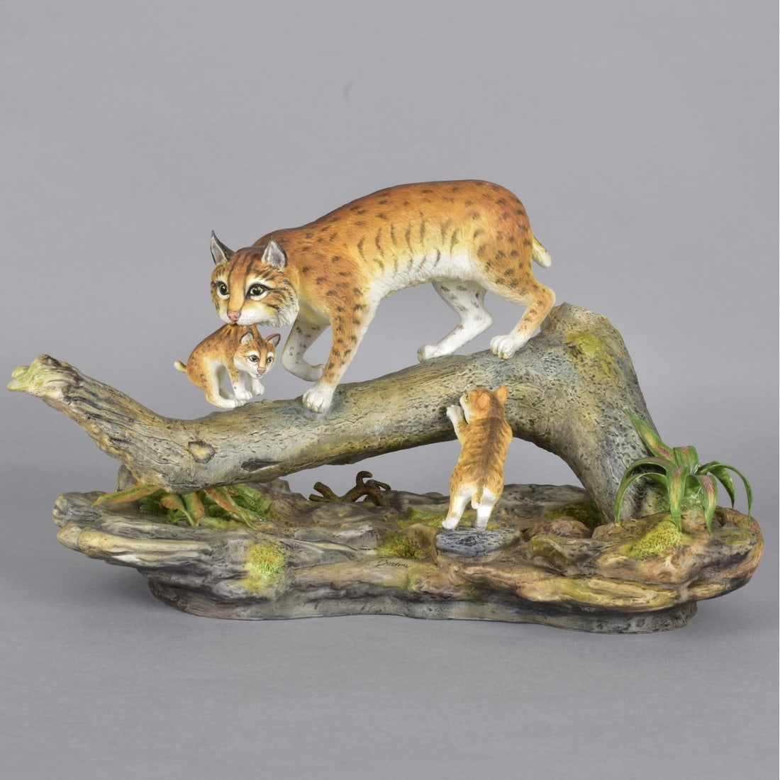Boehm Bobcat and her Cubs Figurine: Boehm England, Mother Bobcat and her Cubs Porcelain Figurine. Signature in front Boehm. Marked to bottom with Black Logo Limited Edition. Measures 9"H x 14"L x 7"W. Condition: Good Condition Estimate: