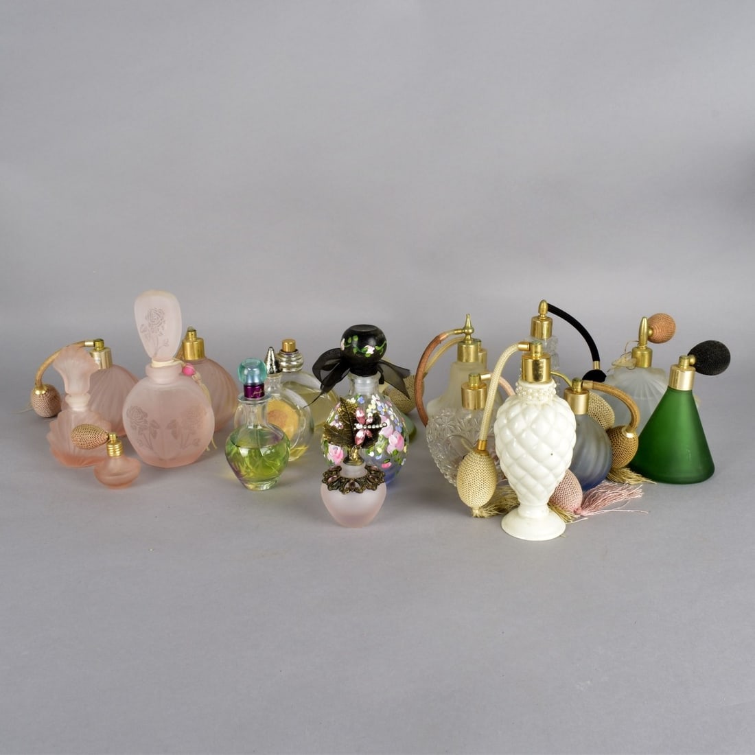 Grouping of Perfume Bottles & Atomizers: Grouping of Twenty Vintage Assorted Perfume Bottles and Atomizers. Tallest measures 6-1/4" x 3-1/4". Condition: Various condition. Estimate: $100.00 - $300.00 Domestic Shipping: Third party