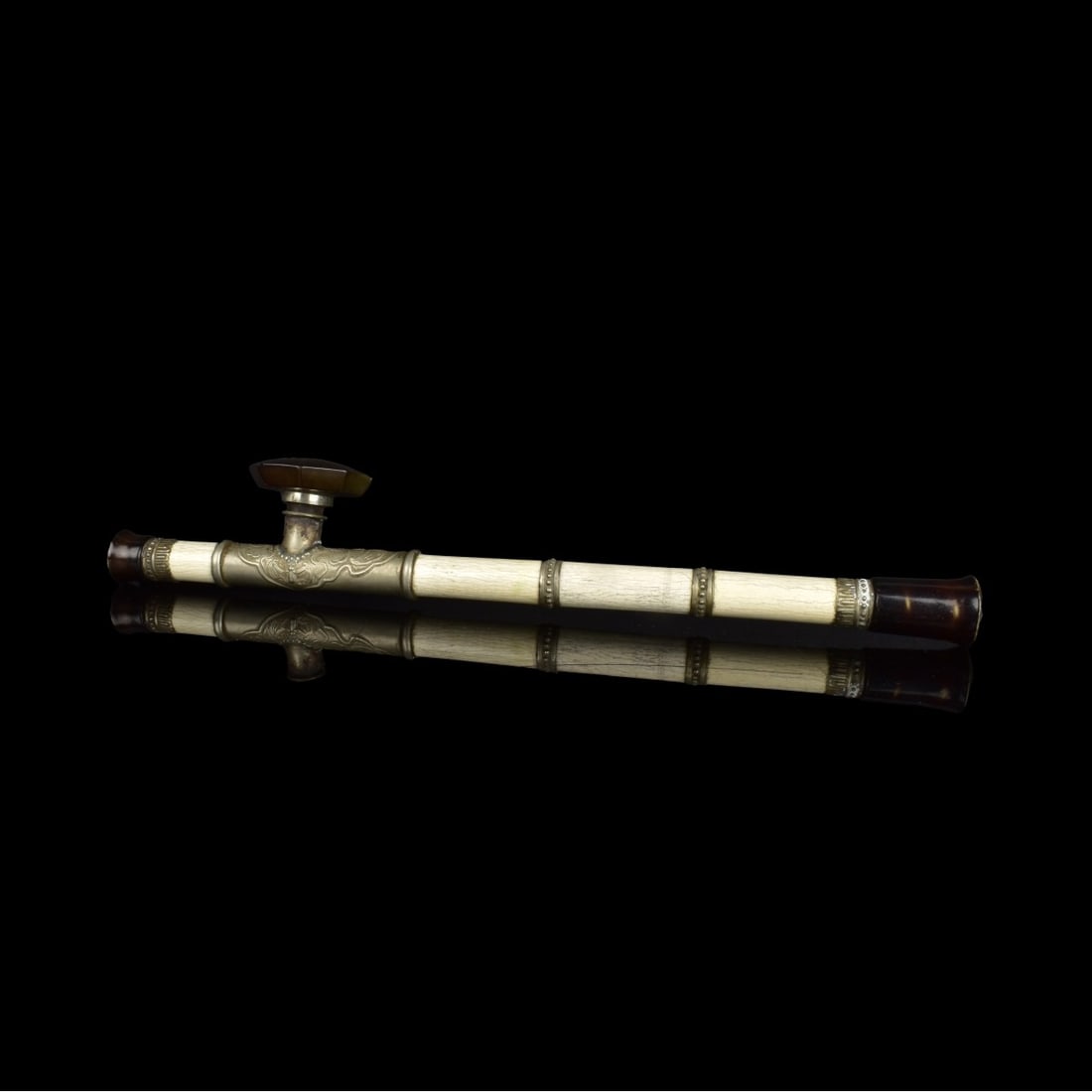 Antique Chinese Opium Pipe: Antique Chinese Carved Bone, Silver and Wood Opium Pipe with Inset Stone. Overall measures 17-1/8" x 3". Condition: Very small nick to the rim of the bowl. Estimate: $200.00 - $400.00 Domestic Shippin