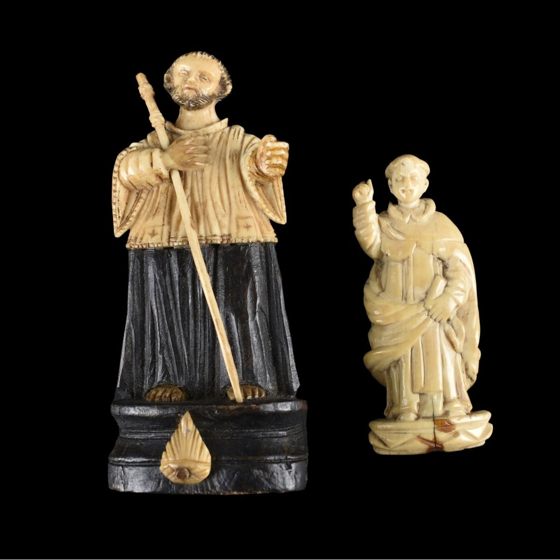 Spanish Colonial Carved Santos Figures: Two 18/19th Century Spanish Colonial Carved Santos Figures. One with carved wood base, possibly ebony). Larger measures 3-3/4" H, 1-5/8" W (at base); smaller measures 2-1/2"H, 1" W. We Will Not Ship T