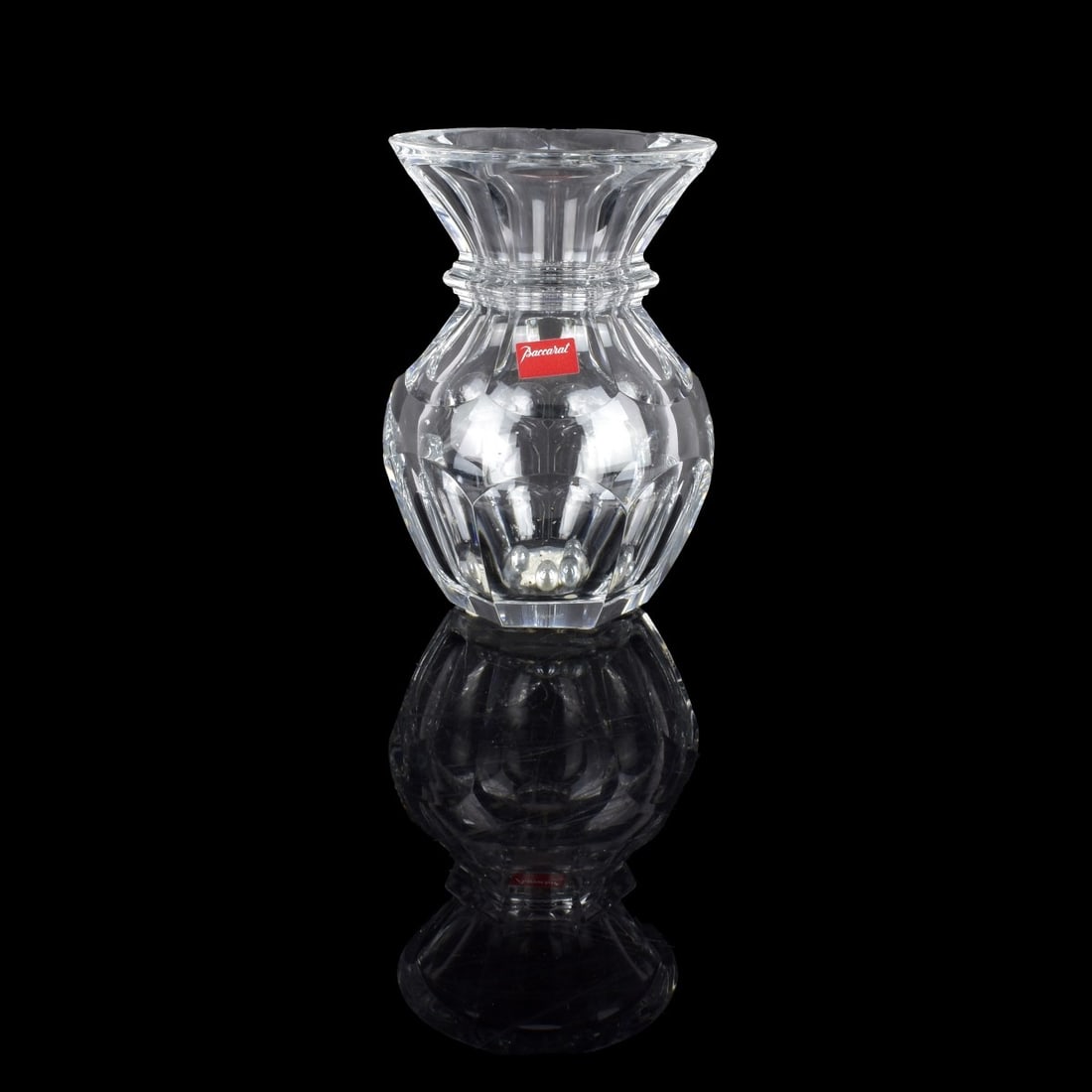 Baccarat Vase: Baccarat "Harcourt" Crystal Faceted Vase. Signed and labels attached to the surface. Measures 8-5/8" x 5-3/4". Condition: Beads and glue to the interior otherwise good condition. Estimate: $100.00 - $