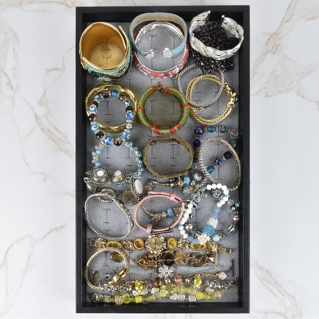Collection of Fashion Bracelets: Collection of Vintage Fashion Bracelets and two Watches. Variously accented with faux diamonds, faux gemstones, enamel, mother of pearl, beads and more. Various styles and makers. Condition: Good vint