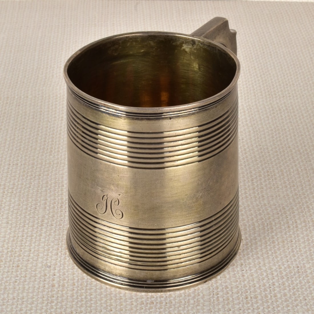 English Sterling Silver Mug: English Sterling Silver Mug with Attached Handle. English hallmarked London 1811. Dedication engraving on bottom reading " J. C. July 15th 1813". 3-1/4" H, 4-1/4" D., (with handle). Weight: 5.14 troy