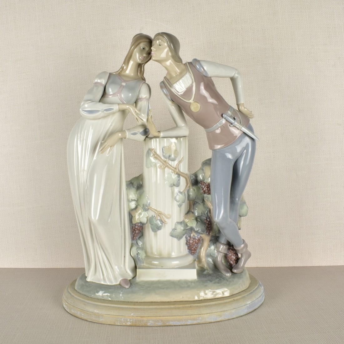 Lladro Romeo & Juliet Porcelain Figurine: A Large Lladro Romeo & Juliet Porcelain Figurine. Mounted on a wood base. Measures: 17" H, 13" W, 5" D. Condition: Good condition, may have been a lamp previously, figurine intact, Estimate: $400.00 -