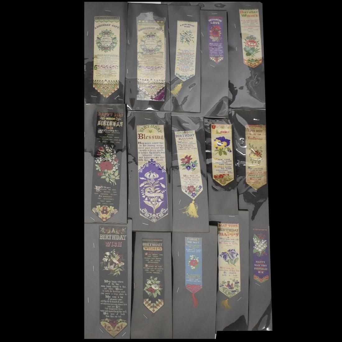 19C Embroidered Silk Bookmarks: Fifteen (15) 19th Century Embroidered Silk Bookmarks. A Birthday Gift and Love etc . All in 8-1/2 x 11 plastic sheets, largest 10-1/8" L smallest 4-3/4" L. Condition: Good used condition, some spots, 