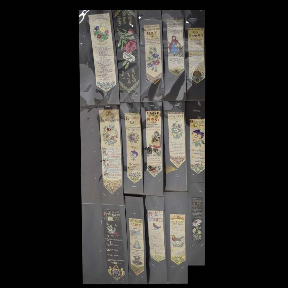 19C Embroidered Silk Bookmarks: Fifteen (15) 19th Century Embroidered Silk Bookmarks. Christmas, New Years, poems red riding hood and cat, Happy returns, remember me and Love etc . All in 8-1/2 x 11 plastic sheets, largest 9-3/4" L 