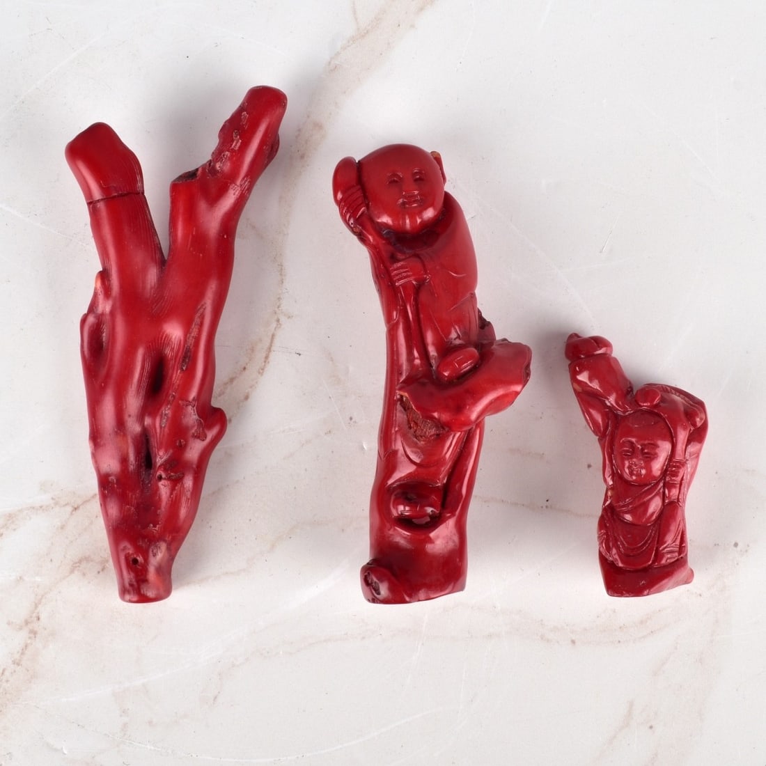 Chinese Coral Carvings: Grouping of Three Chinese Coral Carvings. Largest measures 5-1/4". Smallest measures 2-1/2". Condition: One carving has a repair to one branch. Estimate: $50.00 - $100.00 Domestic Shipping: $55.00