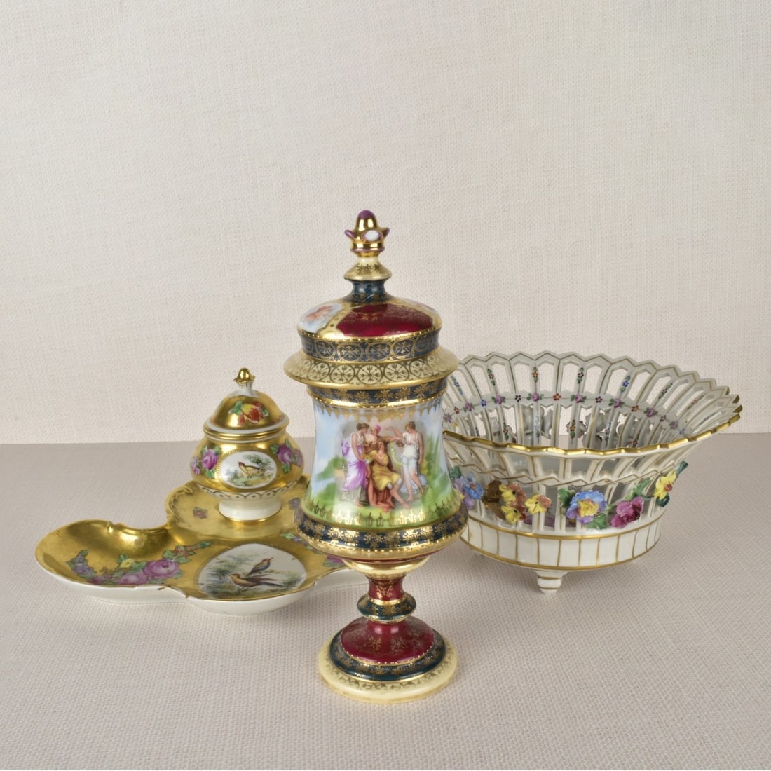 Collection of German Porcelain Pieces: Collection of German Porcelain Pieces. (1) Dresden porcelain reticulated bowl with gold enamel highlights and a garland of flowers encompassing the outside of the bowl with a bouquet of painted flower