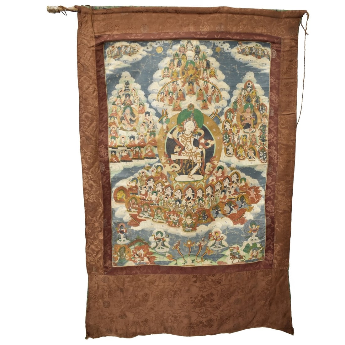 Antique Tibetan Thangka Tapestry: Antique Tibetan Thangka Painting Presented on a Silk Embroidered Tapestry. Overall measures 53" x 31". Condition: Some wrinkle and wear to the thangka from age otherwise good condition. Estimate: $100