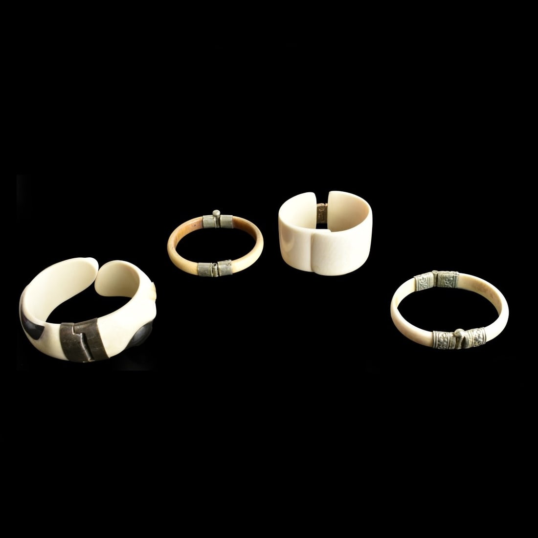 Four Hinged Bracelets: Grouping of Four Hinged Bracelets with Silver Tone Fittings. Largest measures 3" W, 1-1/4" thick. We Will Not Ship This Item Out of State of Florida. Anyone Having This Item Shipped Must Have a Florid