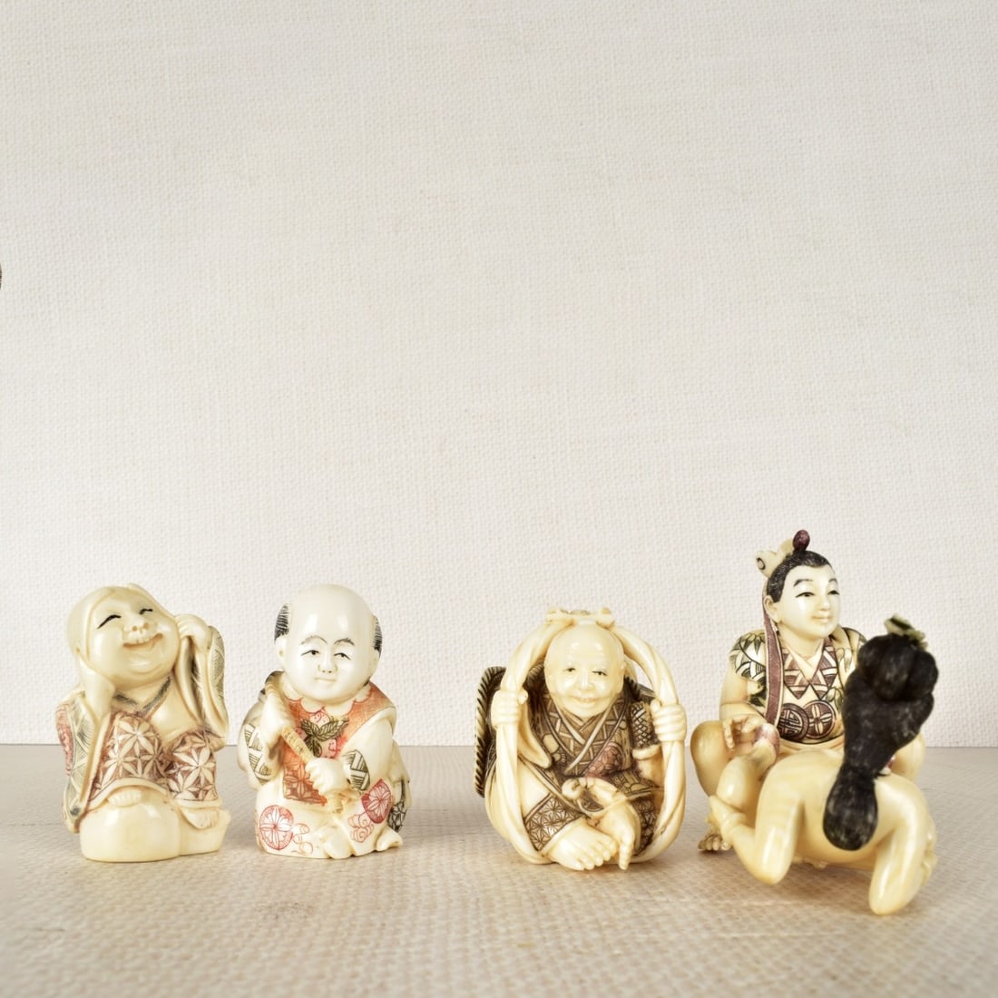 Five Asian Hand Carved Figurines: Five Asian Hand Carved polychrome Figurines, (2) pieces man & female erotic signed to foot, a man with a fish netsuke signed to bottom, happy man unsigned and netsuke man in basket signed to bottom. L
