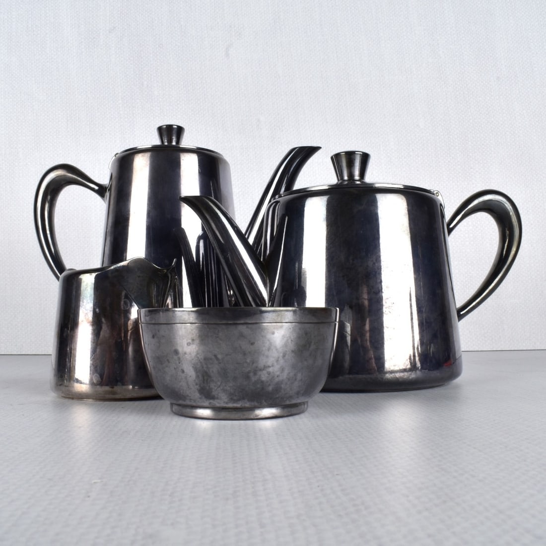 Christofle Coffee/Tea Service: Four (4) Piece Christofle Coffee/Tea Service. Stamped "Christofle" on the bottom of each piece. Largest measures: 6-1/4" H, 8-1/4" W, 3-1/2" D. Condition: Good condition. Estimate: $100.00 - $200.00 D