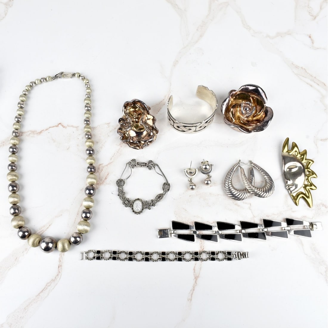 Sterling Silver Jewelry Lot: Tray Lot of Vintage Sterling Silver Jewelry. To include: One necklace, three link bracelets, one cuff bangle bracelet with black onyx, three pins and two pair of earrings. Most stamped 925, some piece