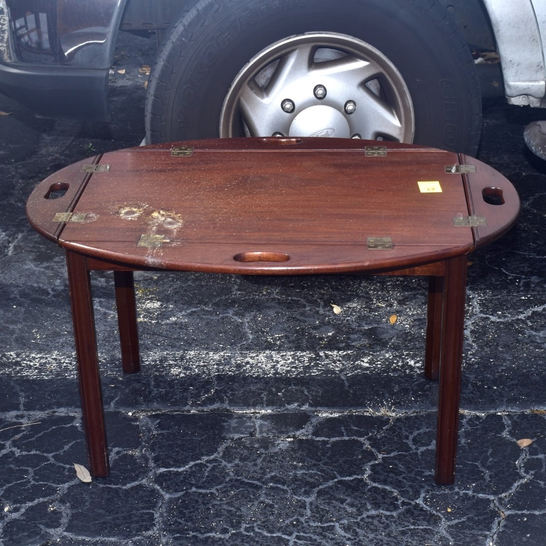 Mahogany Butlers Table: Mahogany Butlers Table, measures with sides down 18-1/4" H, 53-3/4" W, 25" D. Condition: Good used condition, water stain to top. Estimate: $50.00 - $150.00 Domestic Shipping: Third Party