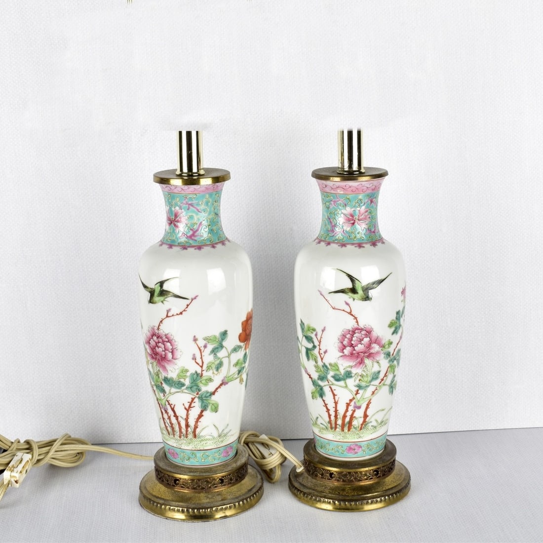 Pair of Chinese Porcelain Lamps: Pair of Chinese Famille Rose Porcelain Lamps, Decorated with Birds and Flowers on a Cream Ground Fixed with Top and Bottom Metal Mounts. Circa 1950. Measures: 16-1/2" H, 4" Dia. Condition: Good condit