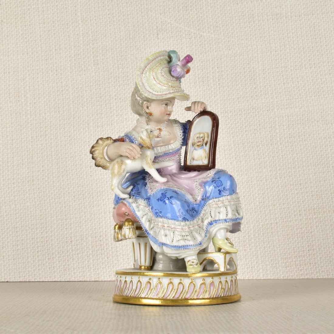 Meissen Figurine of a Lady Sitting with a Dog: Meissen Porcelain Figurine of a Seated Lady Holding a Mirror with A Dogs Reflection. Marked with the Meissen Crossed Swords Under Glaze as well as Incised Number "43" and Number "J30" as well as Paint