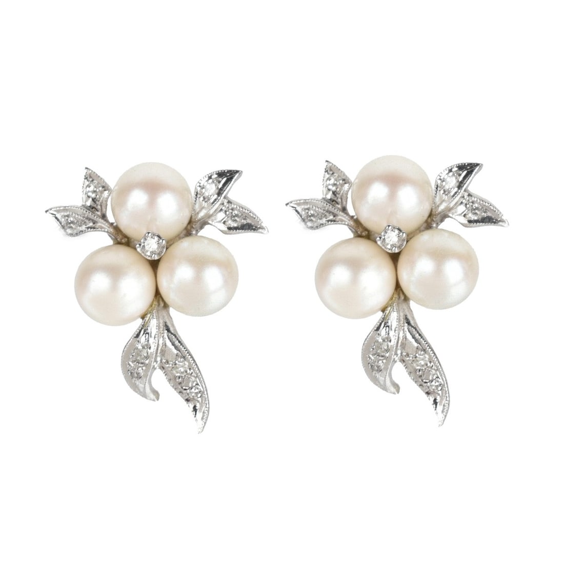 Pearl, Diamond and 14K Earrings: Vintage 7.0mm Pearl, Round Cut Diamond and 14 Karat White Gold Cluster Earrings. Measure 1" x 3/4". Approx. total weight: 6.79 grams. Condition: Very good condition. Estimate: $500.00 - $800.00 Domest