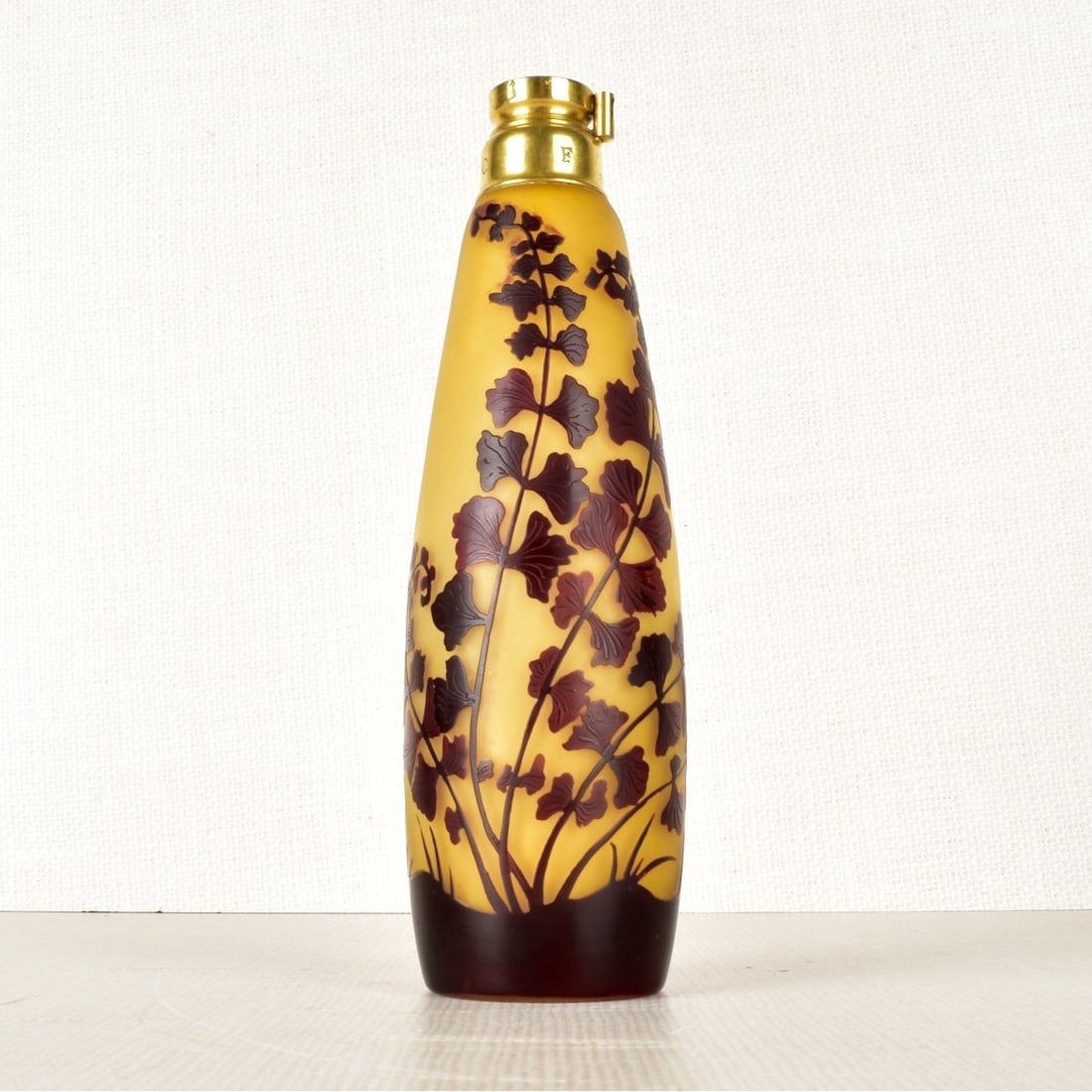 Galle Cameo Atomizer Base: French Galle Cameo Atomizer Base with Brass Fittings, Decorated with Flowers and Vines on a Light Yellow ground. Signed "Galle" in cameo to the side. Circa 1920. Measures: 7-1/2" H, 2-1/2" Dia. Condit