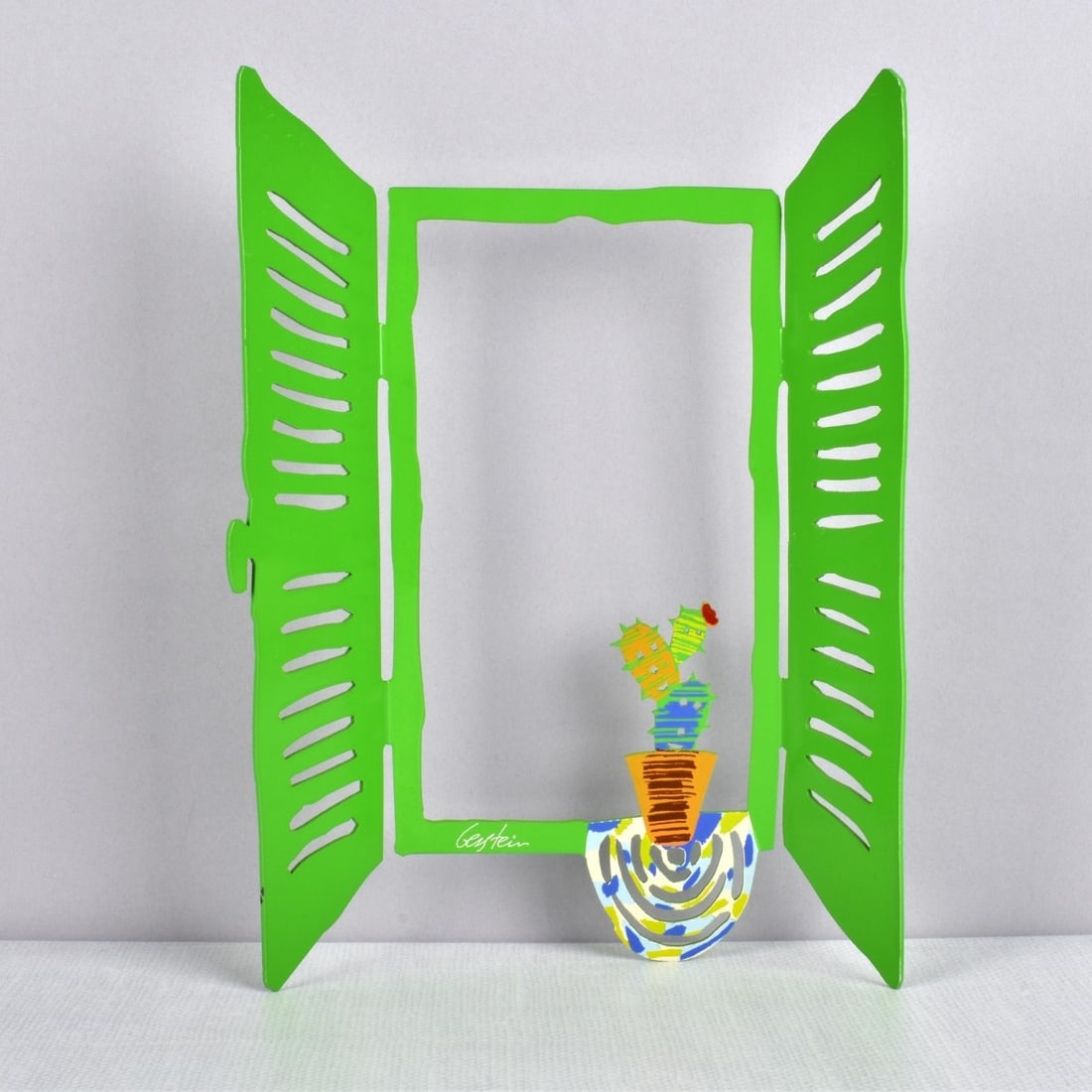 David Gerstein, Israeli (b. 1944): David Gerstein, Israeli (b. 1944) Polychrome Painted Metal Cut Out Figural Sculpture a Flower Pot with a Blooming Cactus. Artist signed. Measures: 12-1/4" H, 6-1/2" W, 2-3/8" D. Condition: Very good c