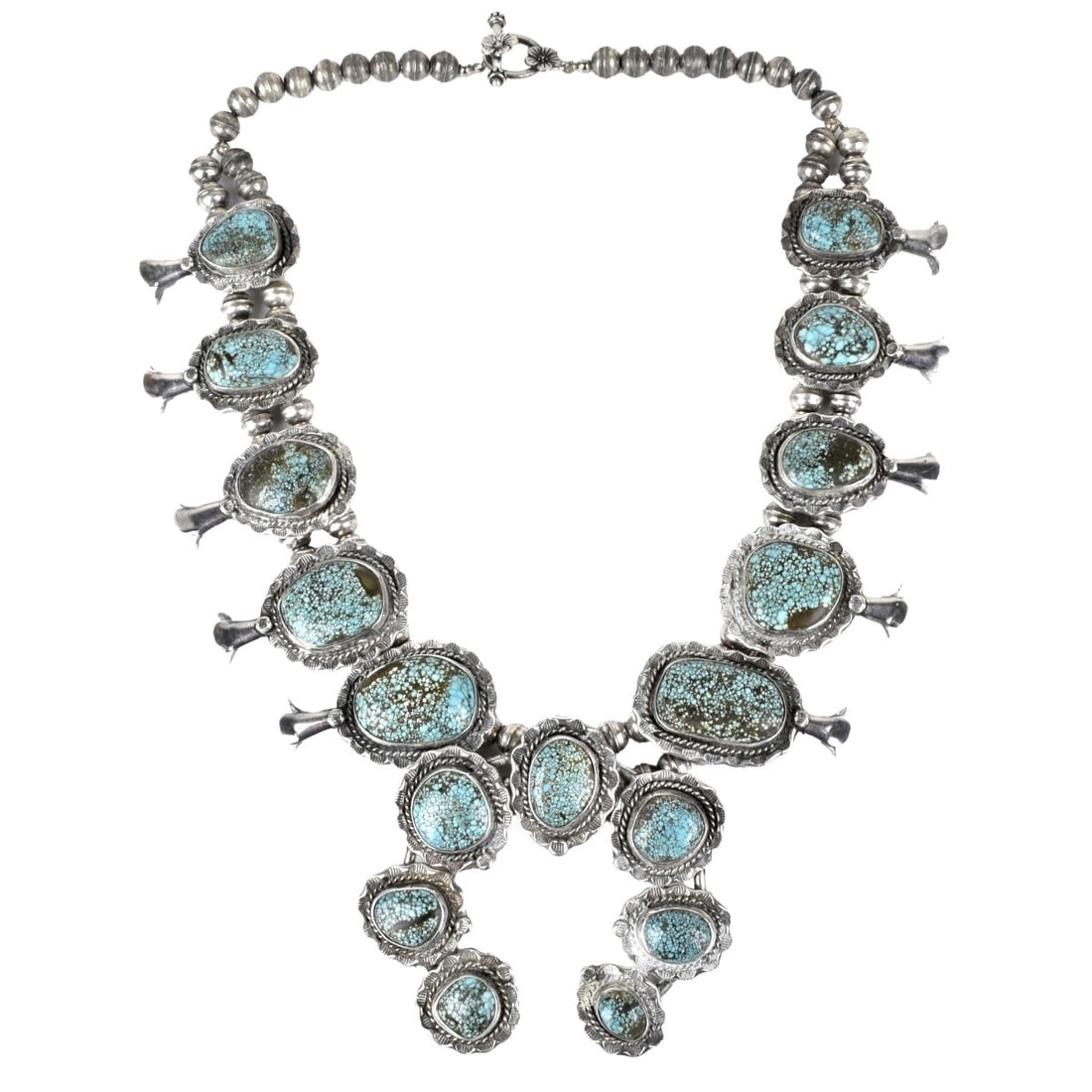 Squash Blossom Necklace: Vintage Southwest Native American Turquoise and Silver Squash Blossom Necklace. Very nice quality with large turquoise nuggets. Measures 20" L, 3" pendant drop. Approx. weight: 212.18 grams. Condition