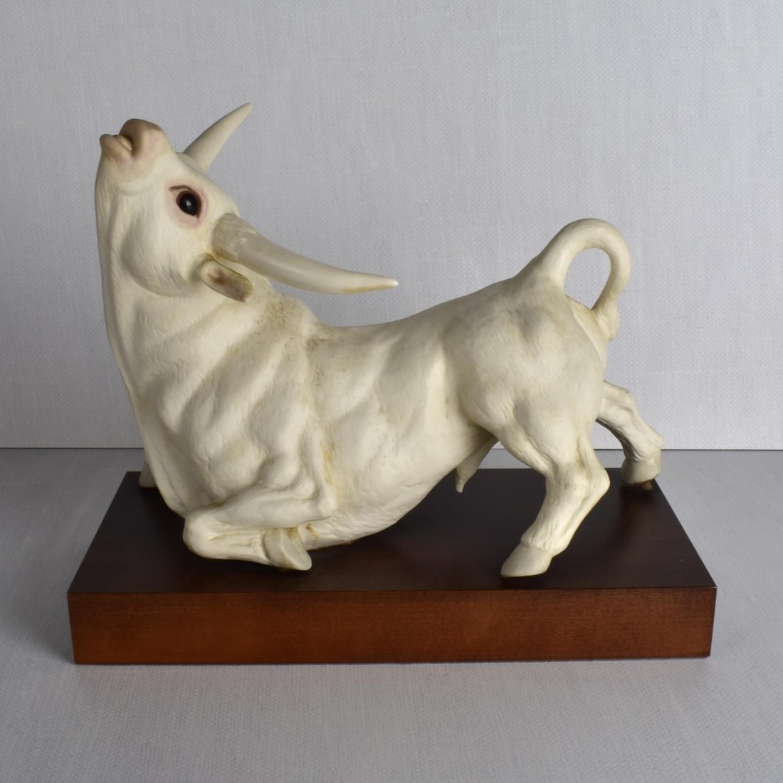 Cybis Bisque Porcelain Sculpture: A Cybis Bisque Porcelain Sculpture of a Braham Bull Mounted on A Wood Base. Properly marked underneath, number 49 (forty nine) of an edition of one hundred (100). Sculpture measures: 9-7'8" H. 13" L,