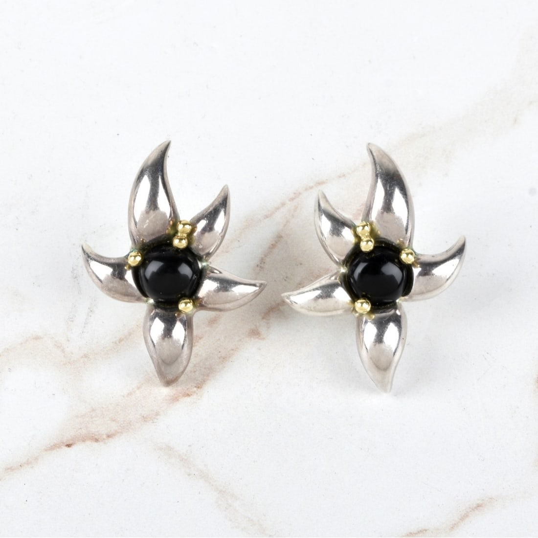 Tiffany and Company Sterling Silver Earrings: Tiffany and Company Sterling Silver And Onyx Earrings. Stamped "Tiffany and Co., .925". Measures: 1-5/8" H, 1-1/4" W. Total gross weight: 19.4 grams Condition: Good condition. Estimate: $100.00 - $200