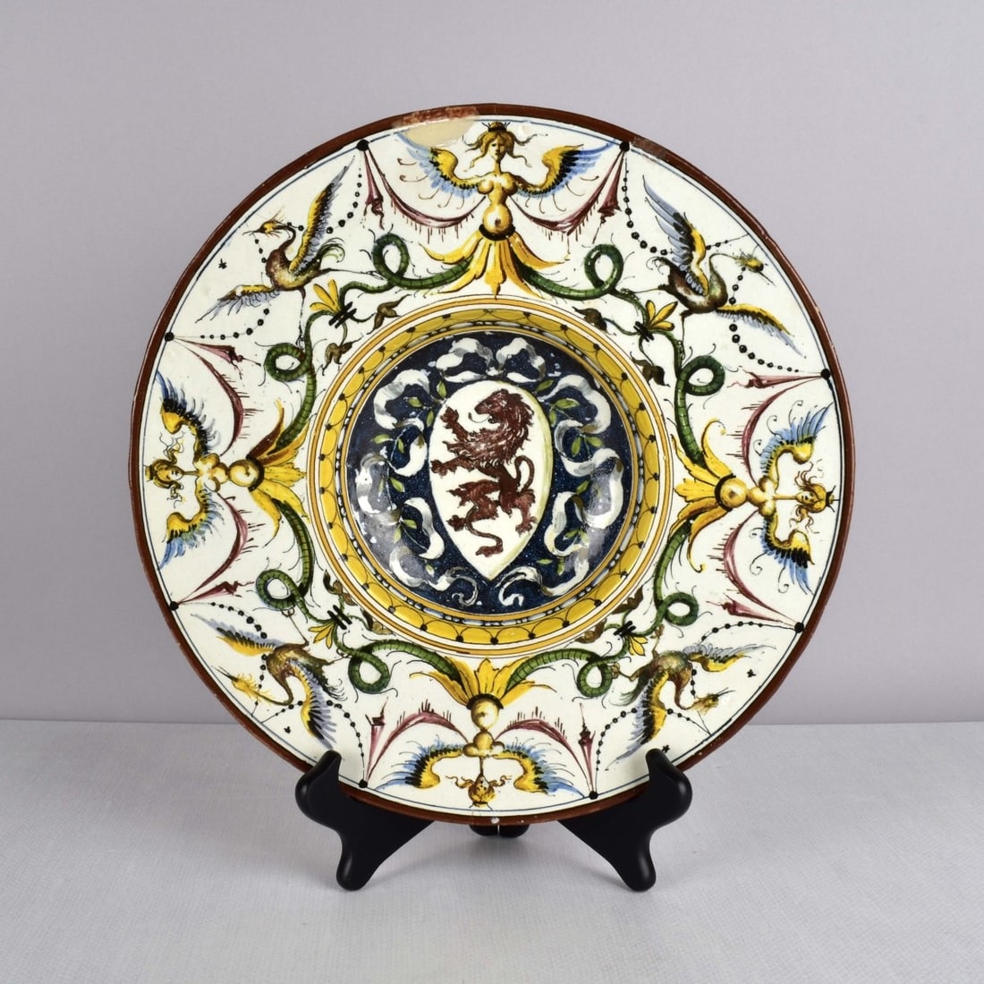 Italian Renaissance Style Round Majolica Bowl: Antique Italian Renaissance Style Round Majolica Bowl. Hand painted with stylized women and birds with a painted central medallion of a lion. Artist signed on the bottom. 18/19th century. Measures: 2-
