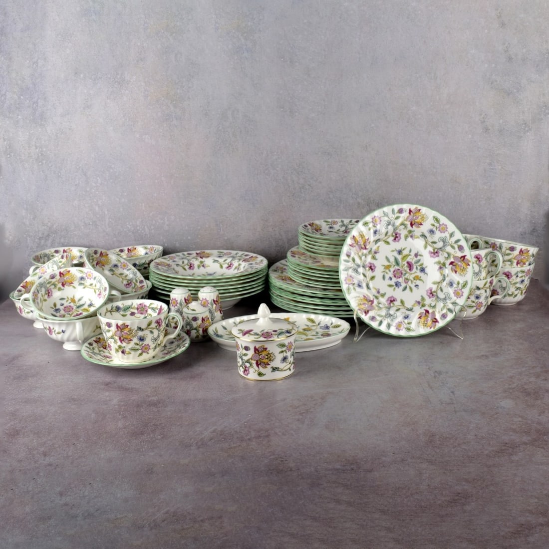 Minton China "Haddon Hall" Dinner Service: Mint Bone China "Haddon Hall" Pattern Dinner Service. Consisting of ten (10) cream soups, seven (7) coffee cups, seven (7) saucers, seven (7) soup bowls, seven (7) luncheon dishes, seven (7) dinner pl