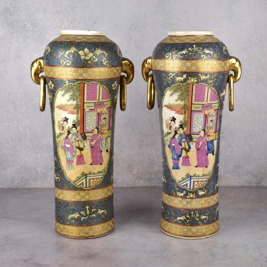 Pair of Chinese Modern Vases: Pair of Chinese Modern Vases. Measures H, sixteen inches (16') W: nine inches, (9"). Each have free moving rings attached. Colors are blue and gold with picture of "Happy Family" Condition: Good Estim