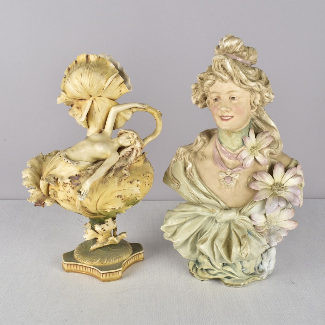 Art Nouveau Porcelain Figural Sculptures: Two (2) Art Nouveau Porcelain Figural Sculptures. Consisting of one (1) Turn Teplitz art nouveau semi-nude figure of a woman amid leaves, properly signed to the bottom. one (1) art nouveau bust of a w