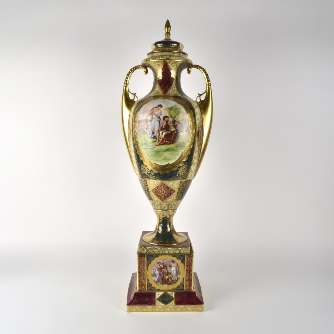 Vienna Cabinet Urn Vase: Vienna Cabinet Urn Vase after Angelica Kaufman, Austrian (1741-1807) in the Style of Royal Vienna with Heavy Gold Gilt Handles and Reserves. Measures: Height: 35", 9" W, 9" D. Condition: Good conditio