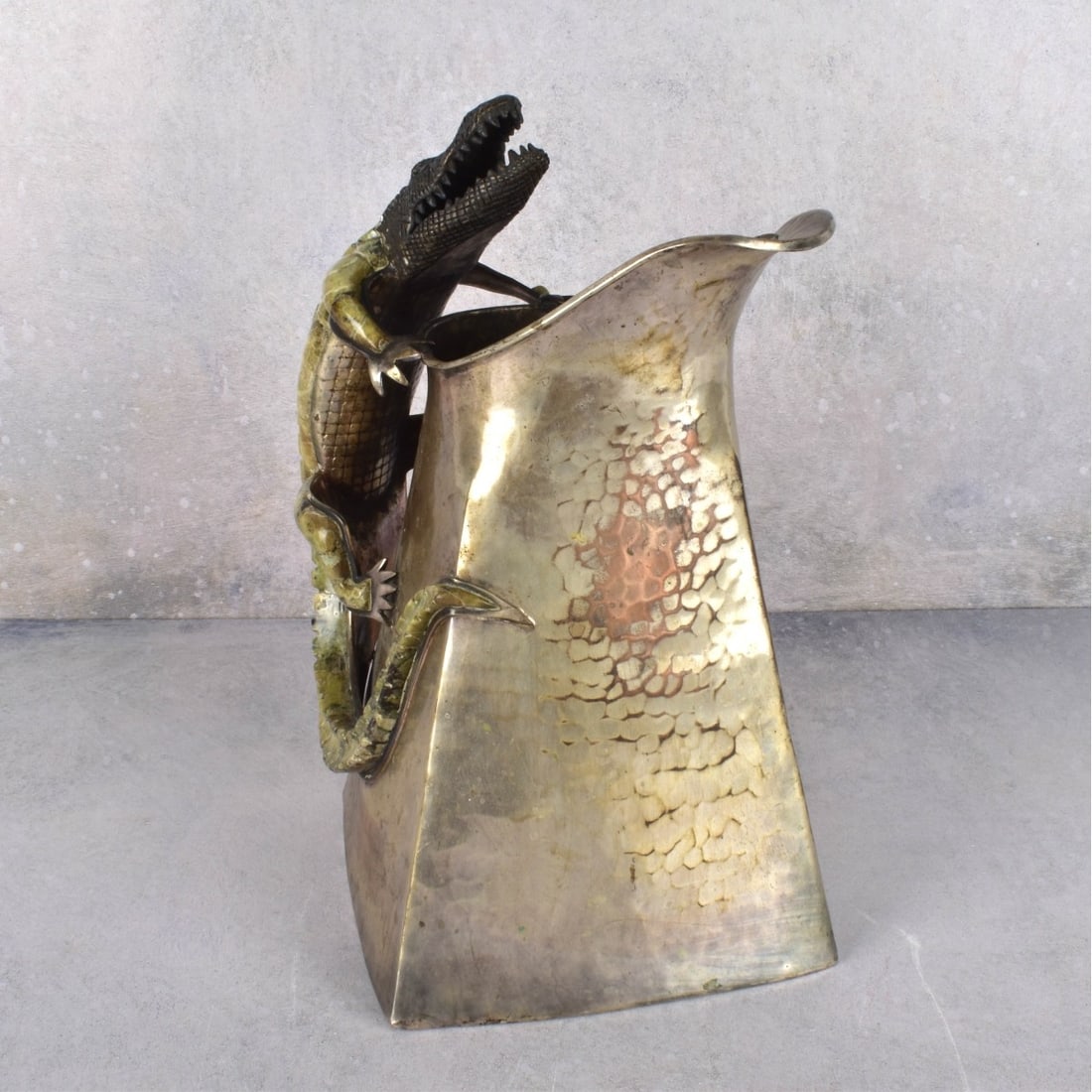 Wolmar Castillo Taxco Pitcher: Wolmar Castillo Taxco Silver Plate Pitcher. Rectangular hand hammered pitcher with attached stone inlaid alligator form handles and applied fish. Stamped Castillo hallmark to the underside. Measures: 