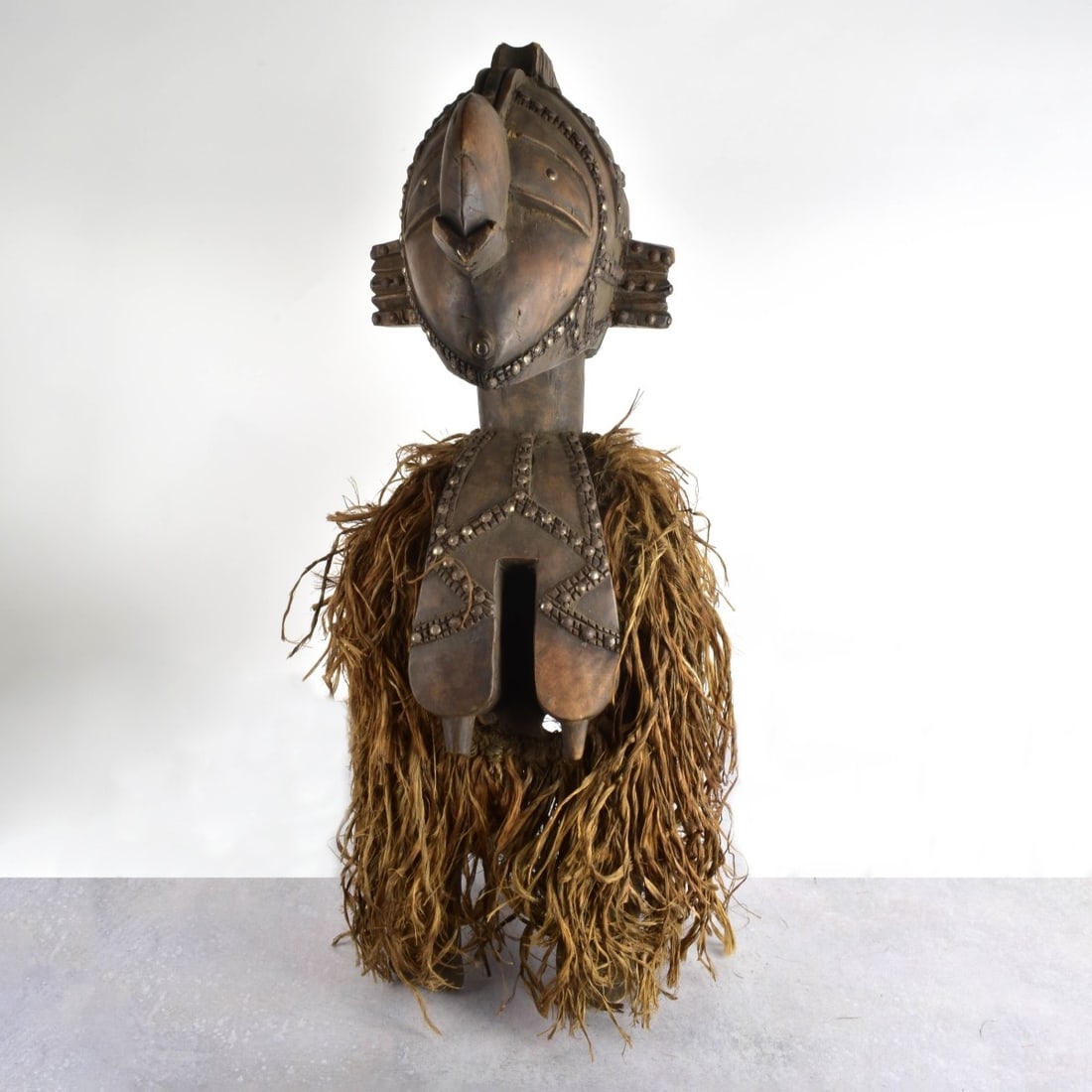 African Saga Nina Fertility Shoulder Mask: African Saga Nina Fertility Shoulder Mask. 20th century. Measures: 32" H, 11" W, 10" D. Kodner Galleries offers phone and absentee bidding at a low, flat 21% buyer’s premium without surcharge or hid