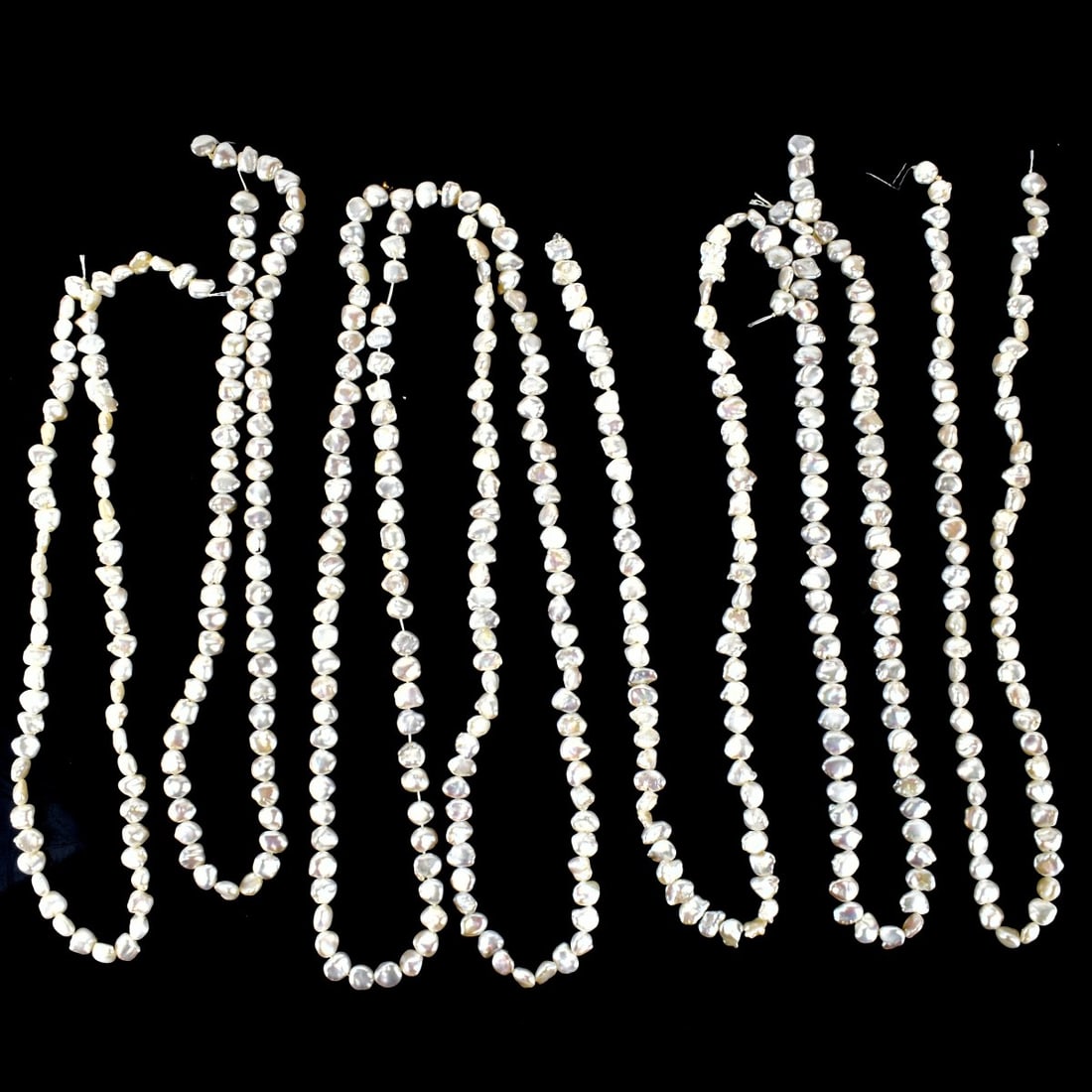 Baroque Pearl Necklaces: Seven Vintage Baroque Pearl Necklaces. Pearls measure 6.0-7.0mm. No clasps. Necklace measure 16-1/2" L. Kodner Galleries offers phone and absentee bidding at a low, flat 21% buyer’s premium without 