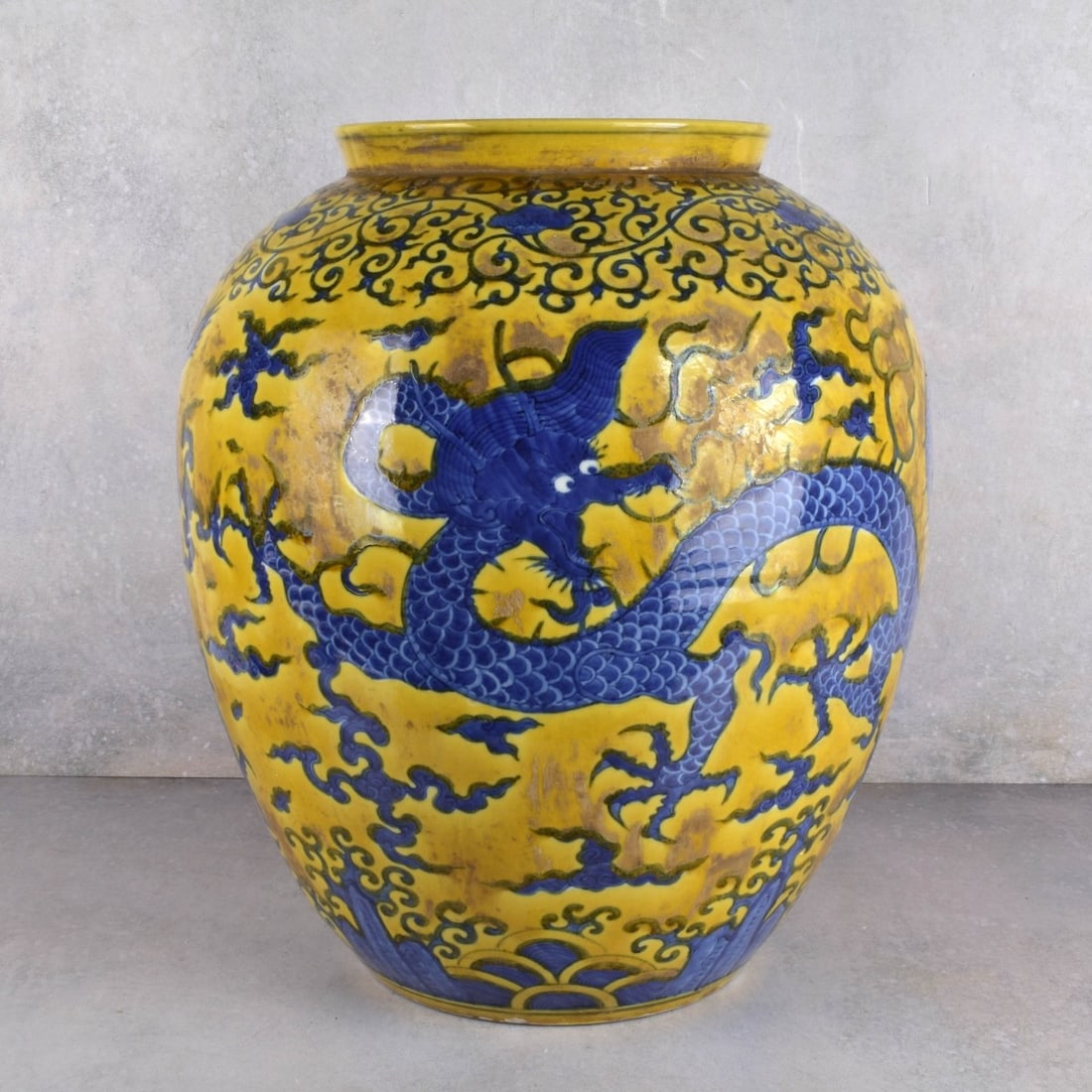 Chinese Yellow Glaze Porcelain Jar: Chinese Yellow Glaze Porcelain Jar Decorated with Cobalt Blue Dragons all Around. Measures: 18-1/4" H., 15" Dia. Kodner Galleries offers phone and absentee bidding at a low, flat 21% buyer’s premium