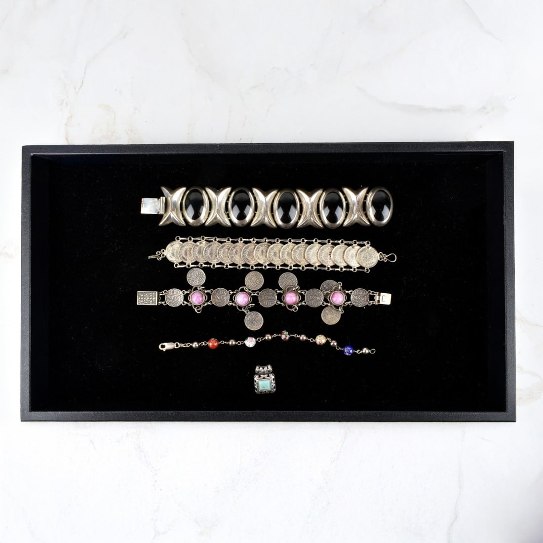 Silver Jewelry: Vintage Silver Jewelry. To include Mexican sterling silver and black onyx 'XO" bracelet; a turquoise and sterling pendant; a sterling and enamel bead bracelet; a silver 1979 Costa Rica coin link brace