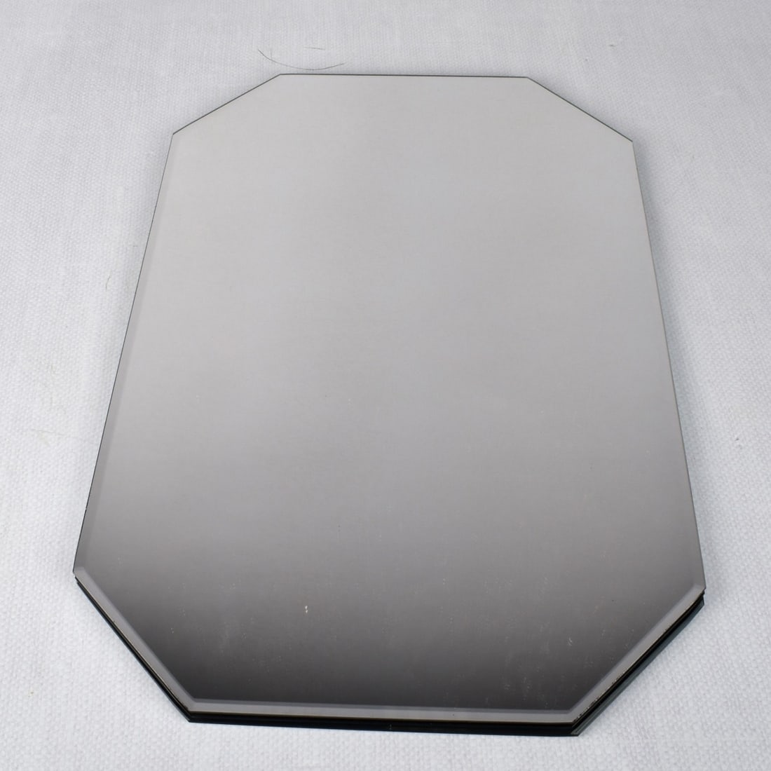 Glass Mirror Place Mats: Fifteen (15) Glass Mirror Place Mats. Measures: 18" H, 12" W, Kodner Galleries offers phone and absentee bidding at a low, flat 21% buyer’s premium without surcharge or hidden fees. For information,