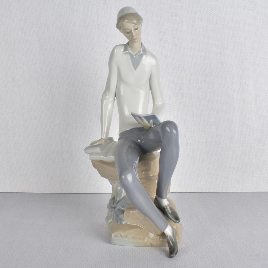 Lladro Porcelain Figurine of a Student: Lladro Porcelain Figurine of a Hebrew Student. Properly marked to the bottom. Measures: 11-1/4" H, 4-1/2" W , 6-1/2" D. Kodner Galleries offers phone and absentee bidding at a low, flat 21% buyer’s